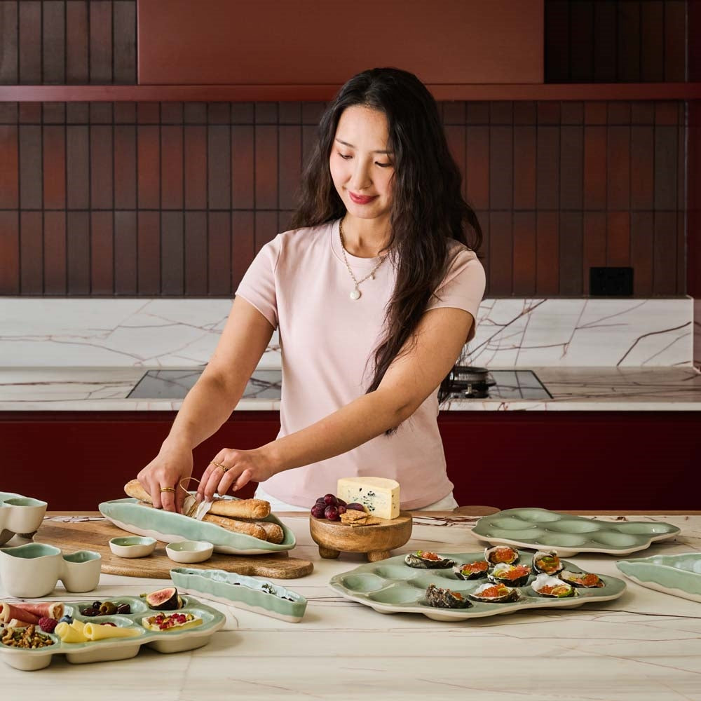 Stoneware olive bowl with a matte neutral outside and glossy green glazed inside
