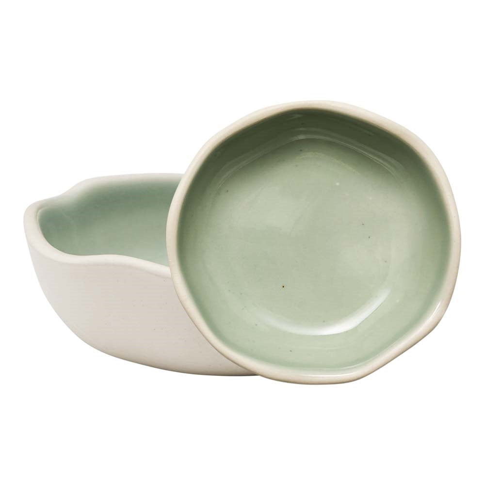 Two small stoneware condiment bowls with glossy green glazed insides