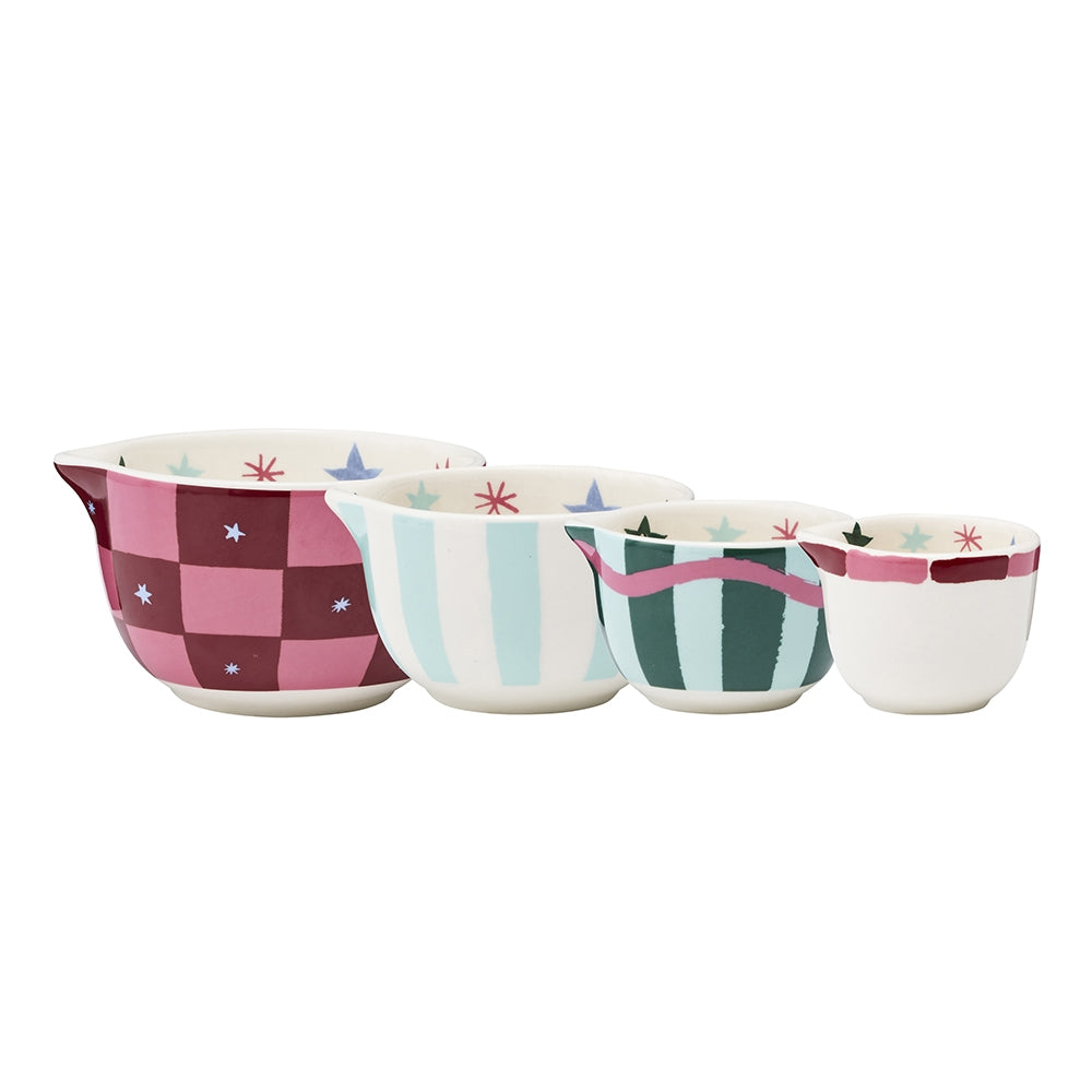 Four Christmas print stoneware measuring cups in red, pink and green