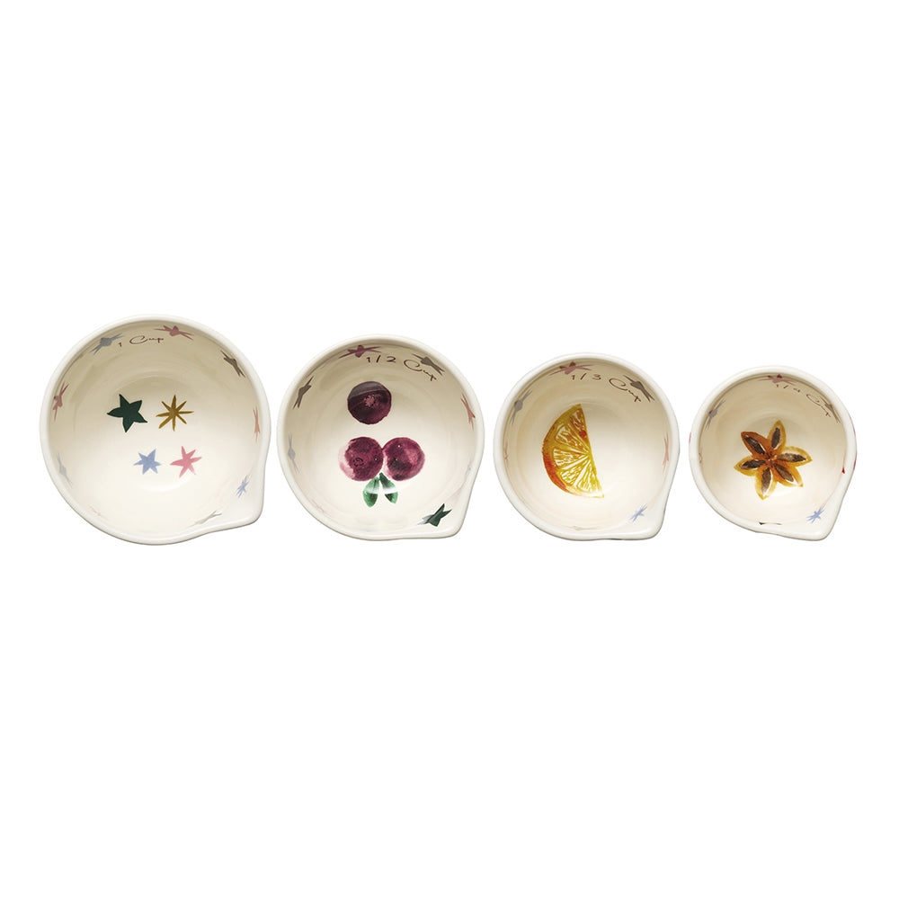 Four Christmas print stoneware measuring cups in red, pink and green