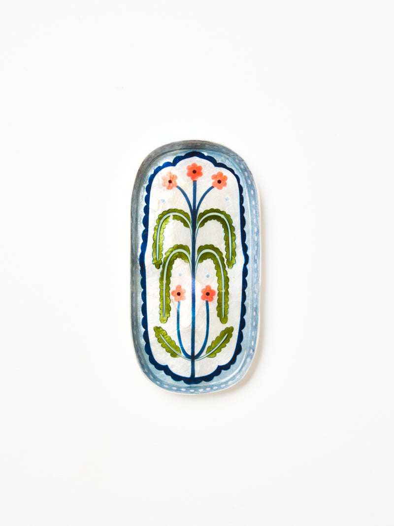 Close up of the hand painted flowering plant on the capiz tray