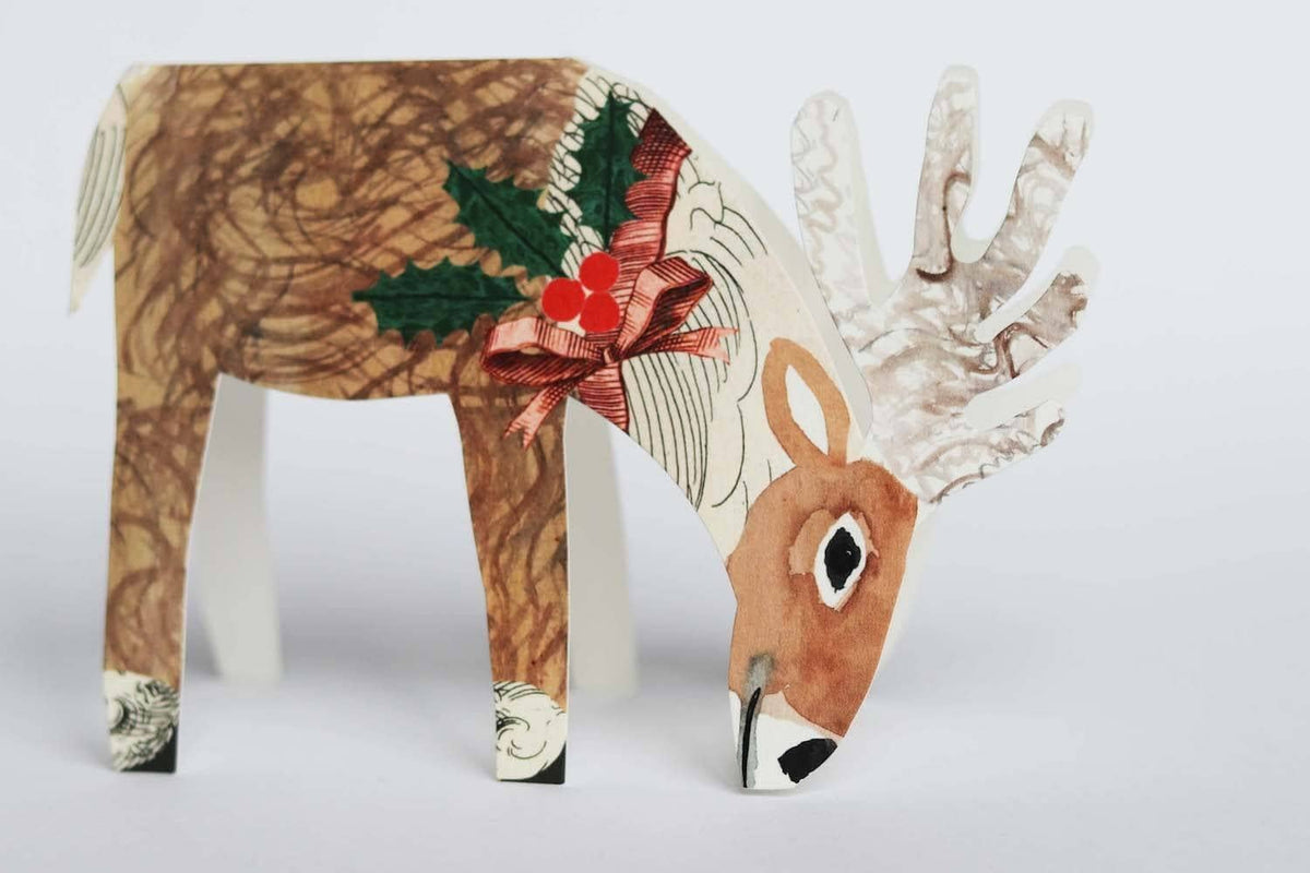 Hadley Christmas card of a reindeer wearing a bow with holly detail