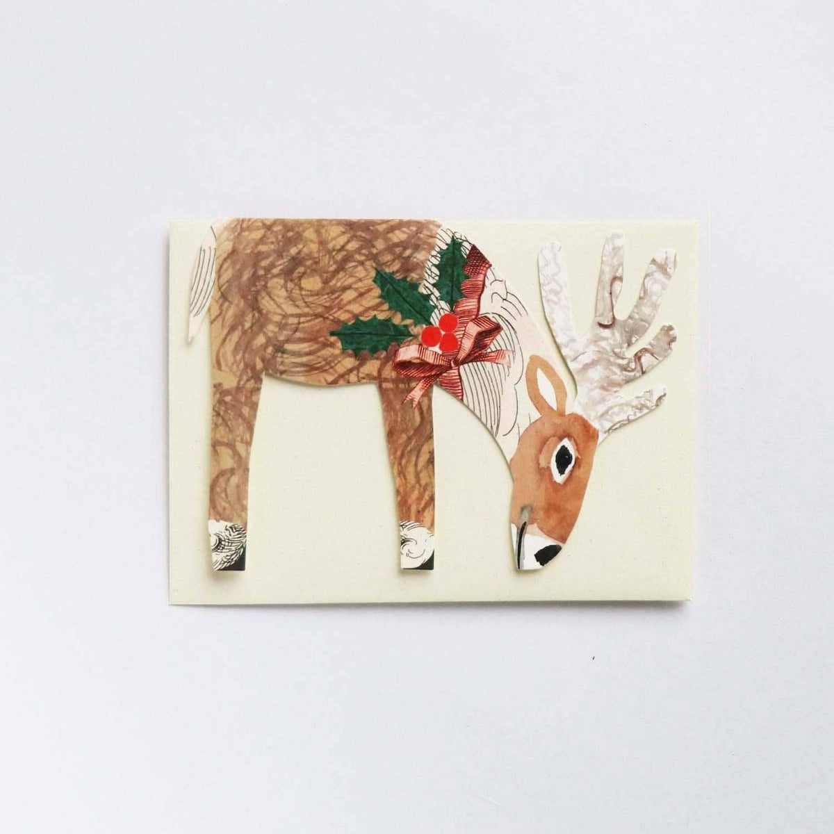 Hadley Christmas card of a reindeer wearing a bow with holly detail