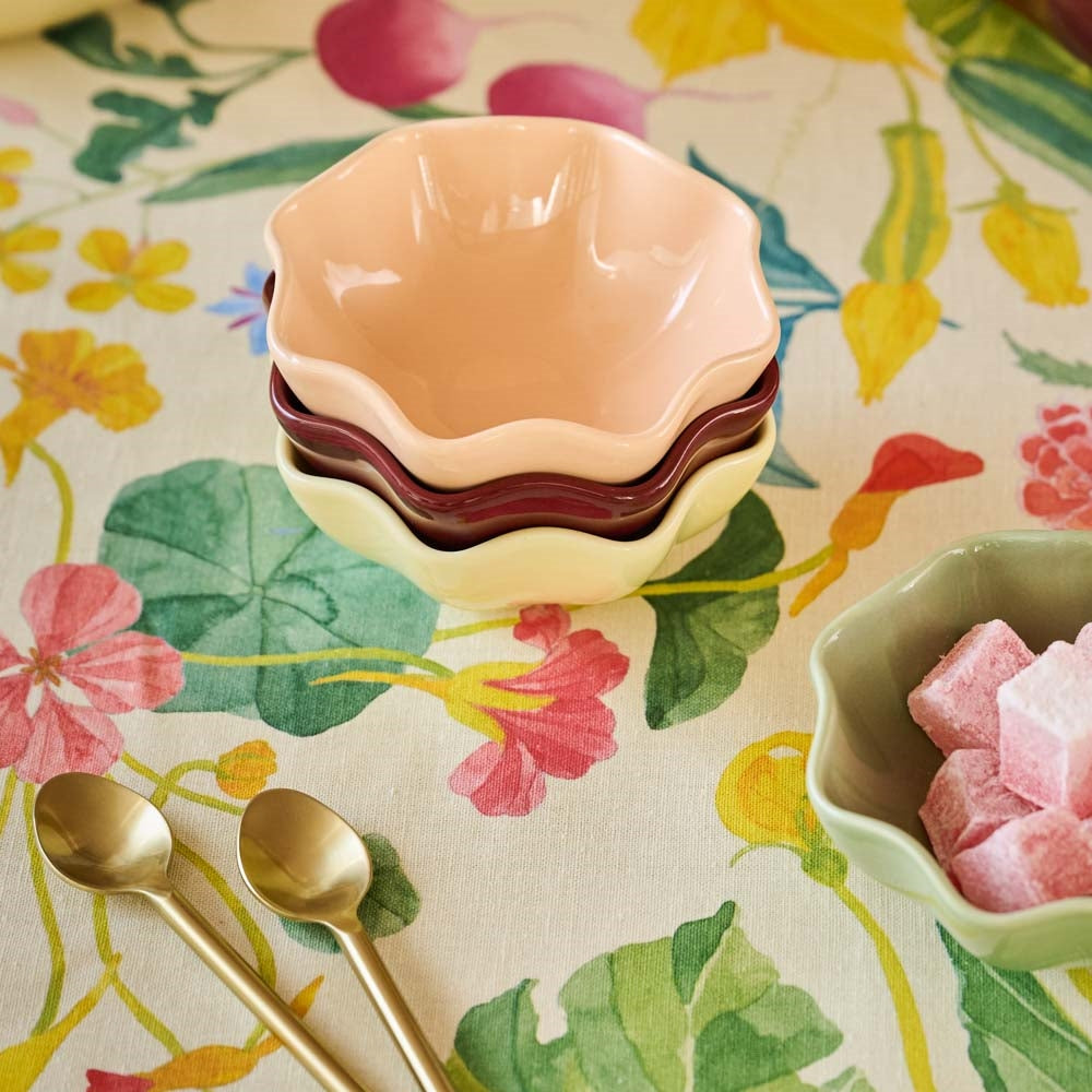 Four flower shaped fluted porcelain dip bowls in assorted colours
