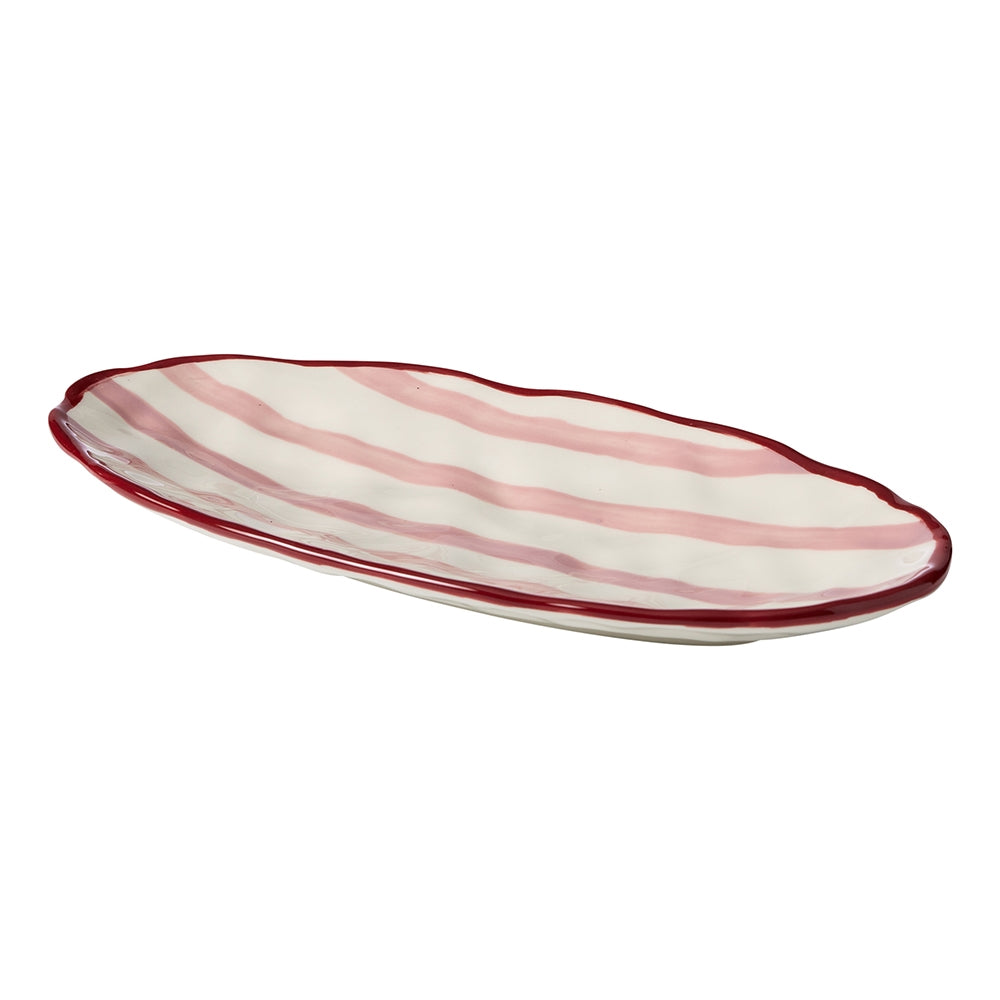 Oval stoneware platter with red stripes, a maroon rim and dimpled texture