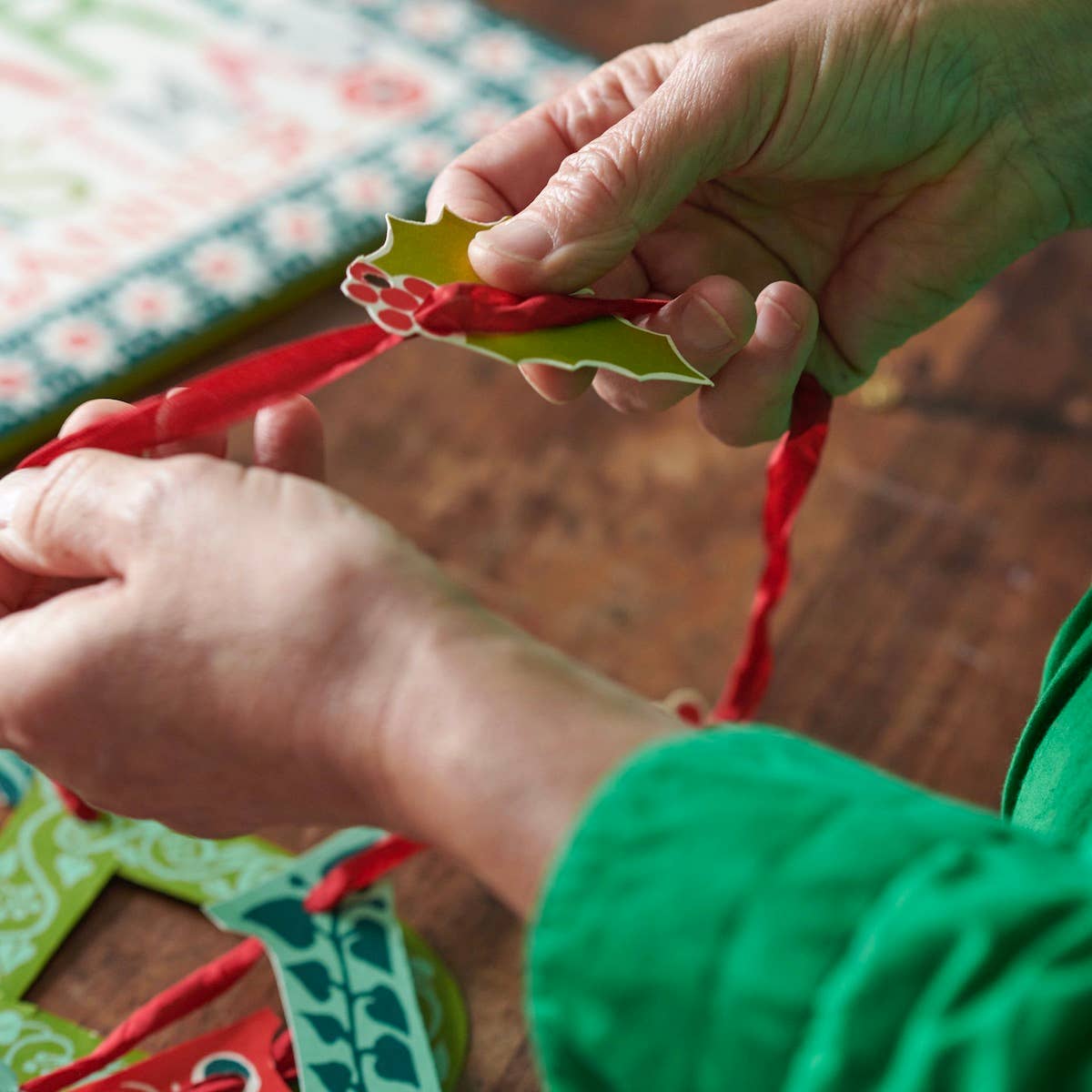 Cambridge Imprint Merry Christmas paper banner with red and green patterned letters and holly sprigs, view 4